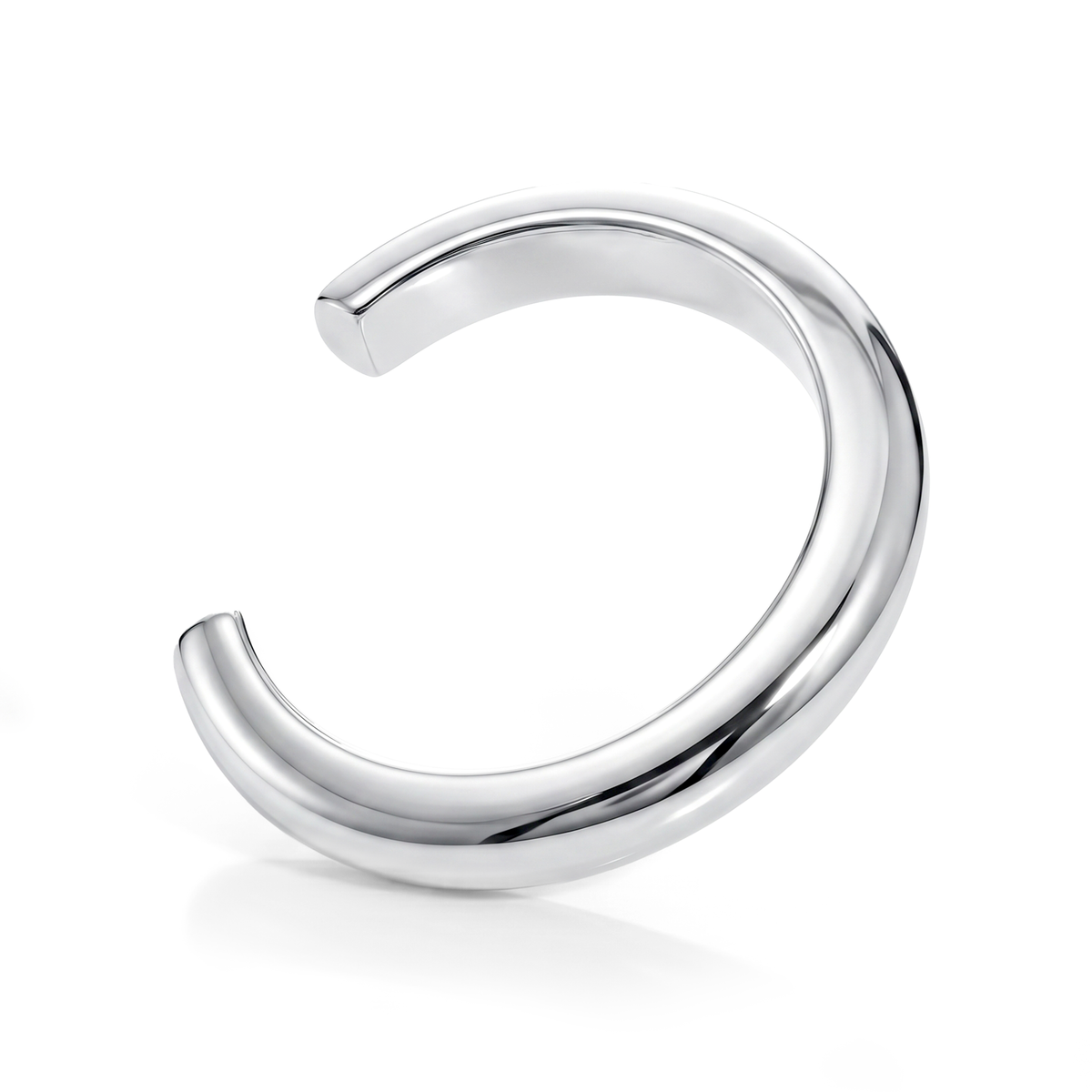 Sculptural cuff bracelet available in gold plated and rhodium plated finishes with bold circular design