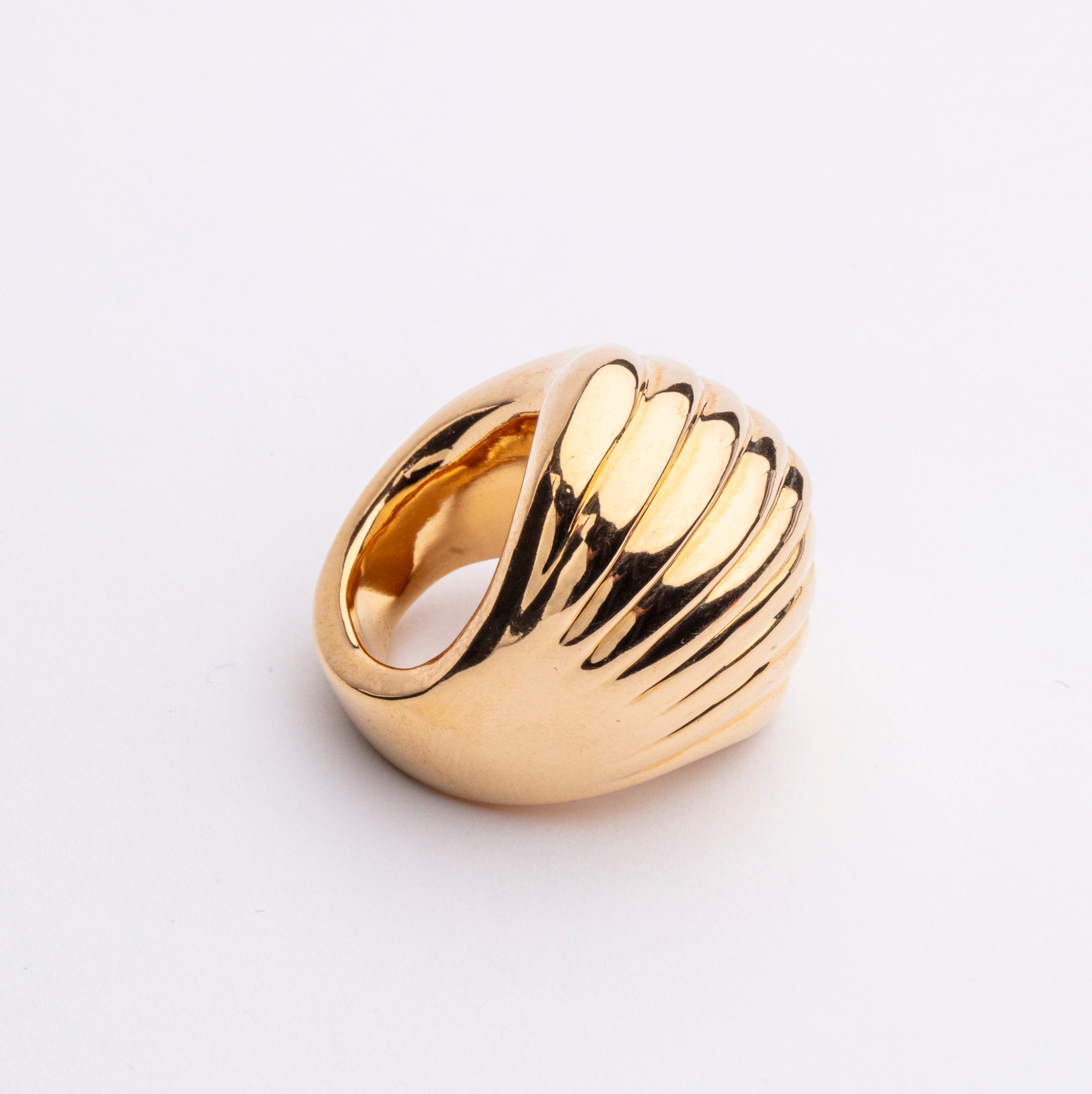Gold plated wave sculptural ring with fluid curved design and polished finish