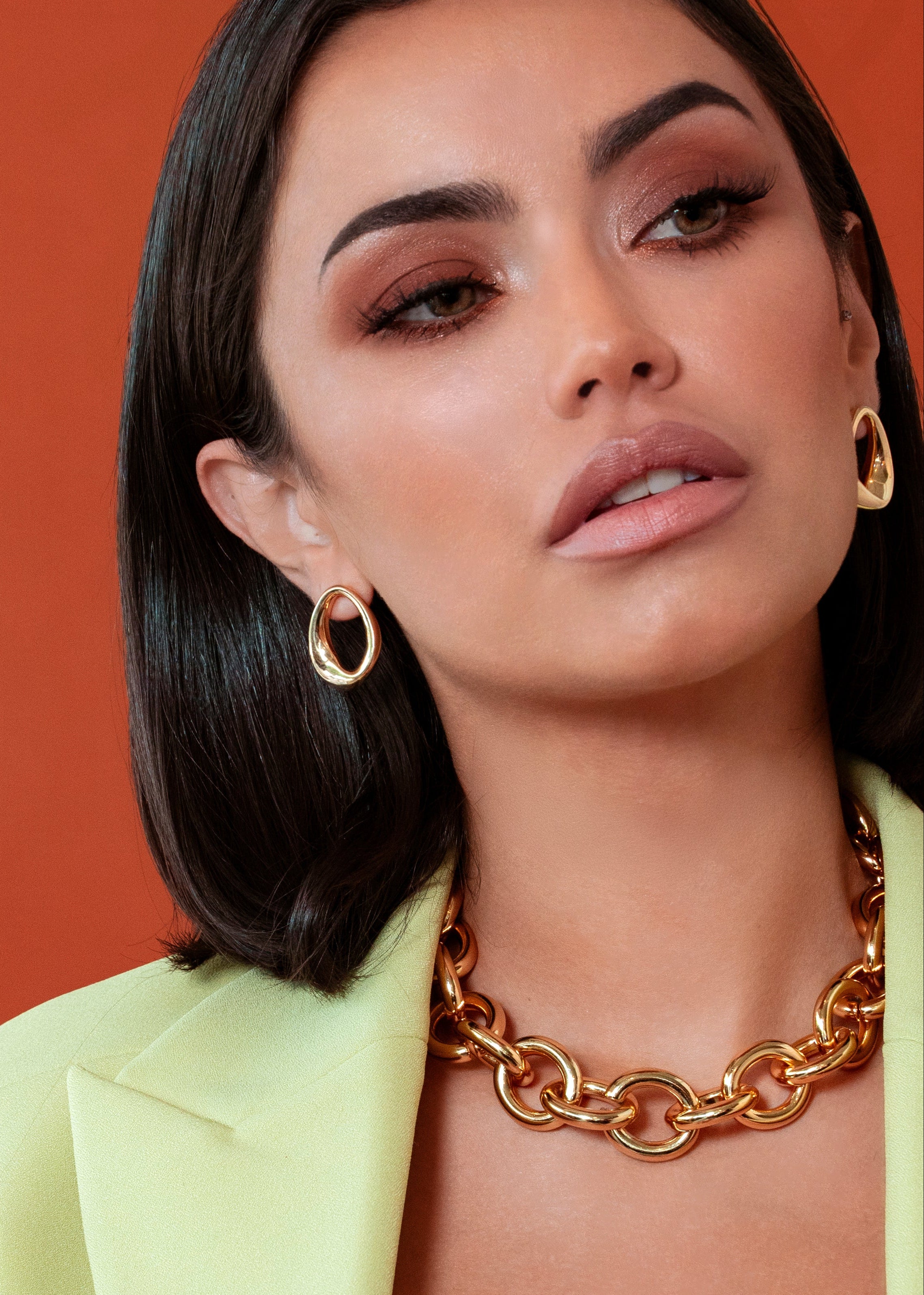 Abstract oval earrings available in gold plated and rhodium plated finishes with sculptural geometric design
