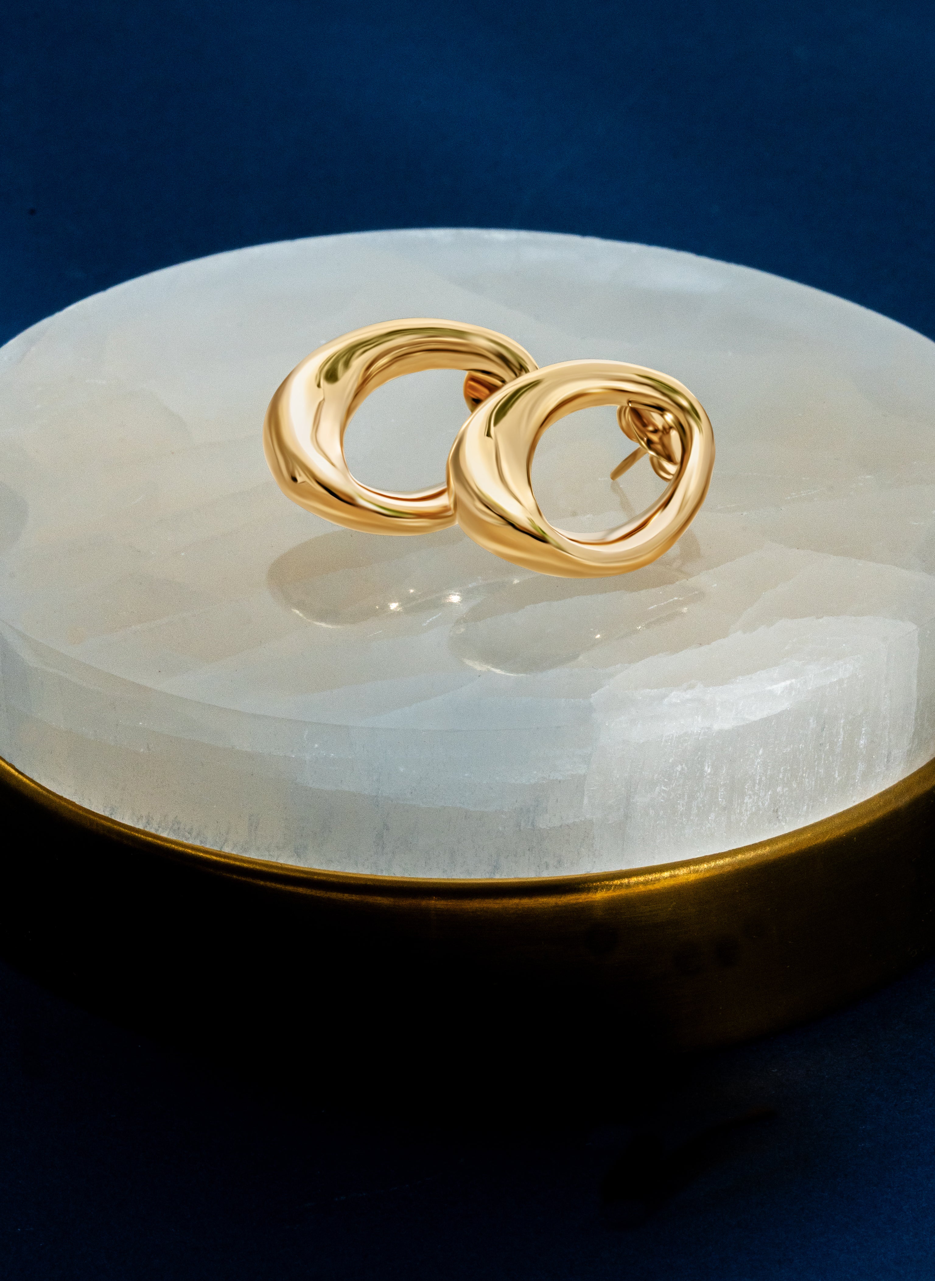 Abstract oval earrings available in gold plated and rhodium plated finishes with sculptural geometric design