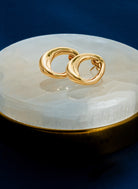 Abstract oval earrings available in gold plated and rhodium plated finishes with sculptural geometric design