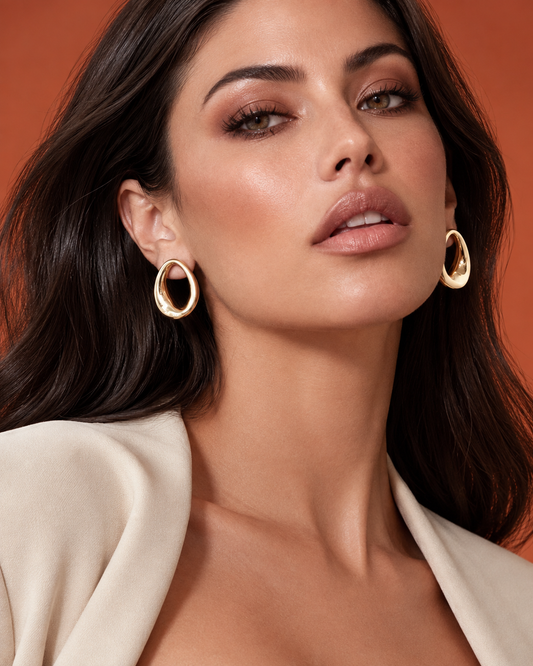 Abstract oval earrings available in gold plated and rhodium plated finishes with sculptural geometric design