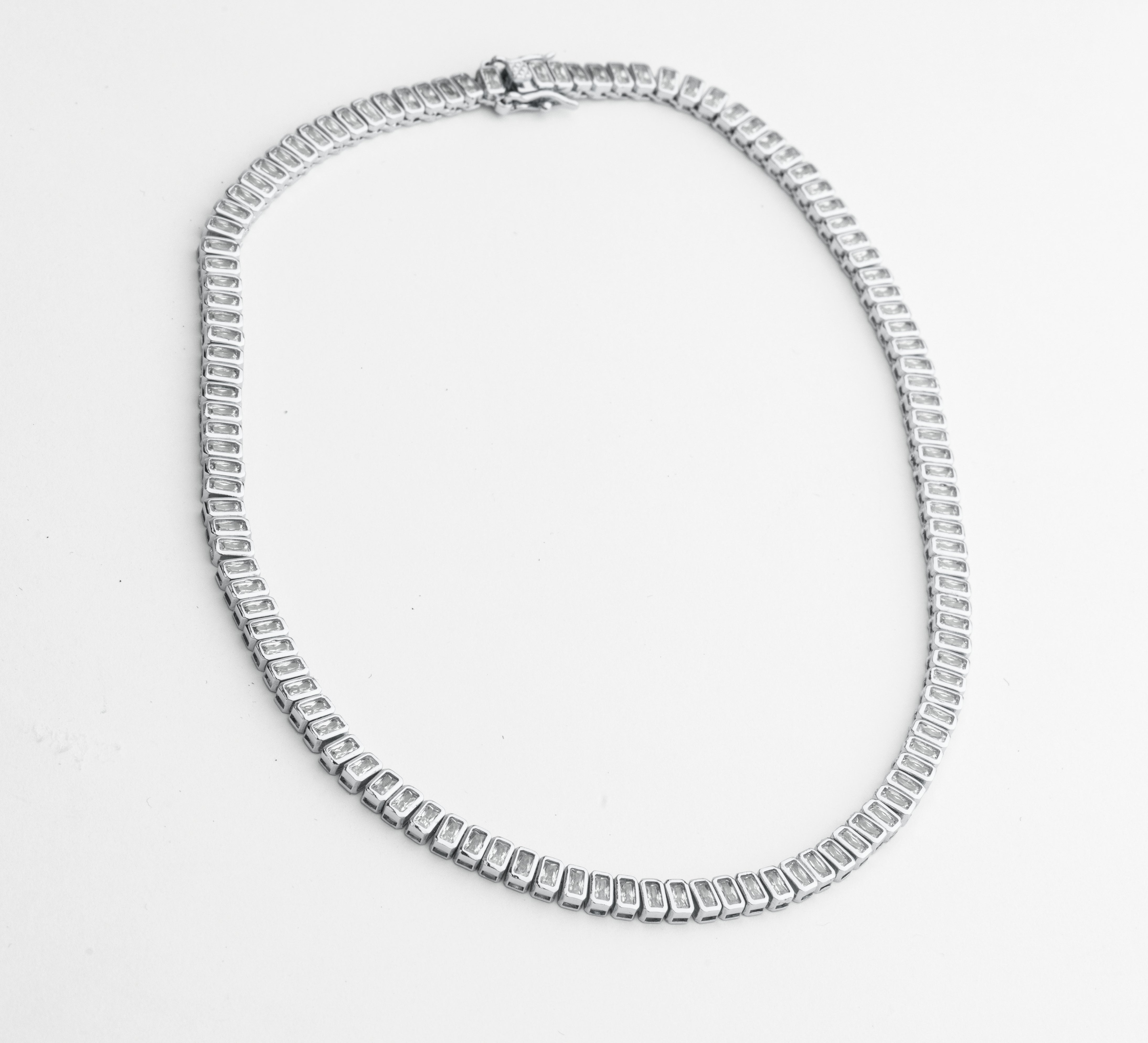 Cubic zirconia necklace available in gold plated and rhodium plated finishes with high shine