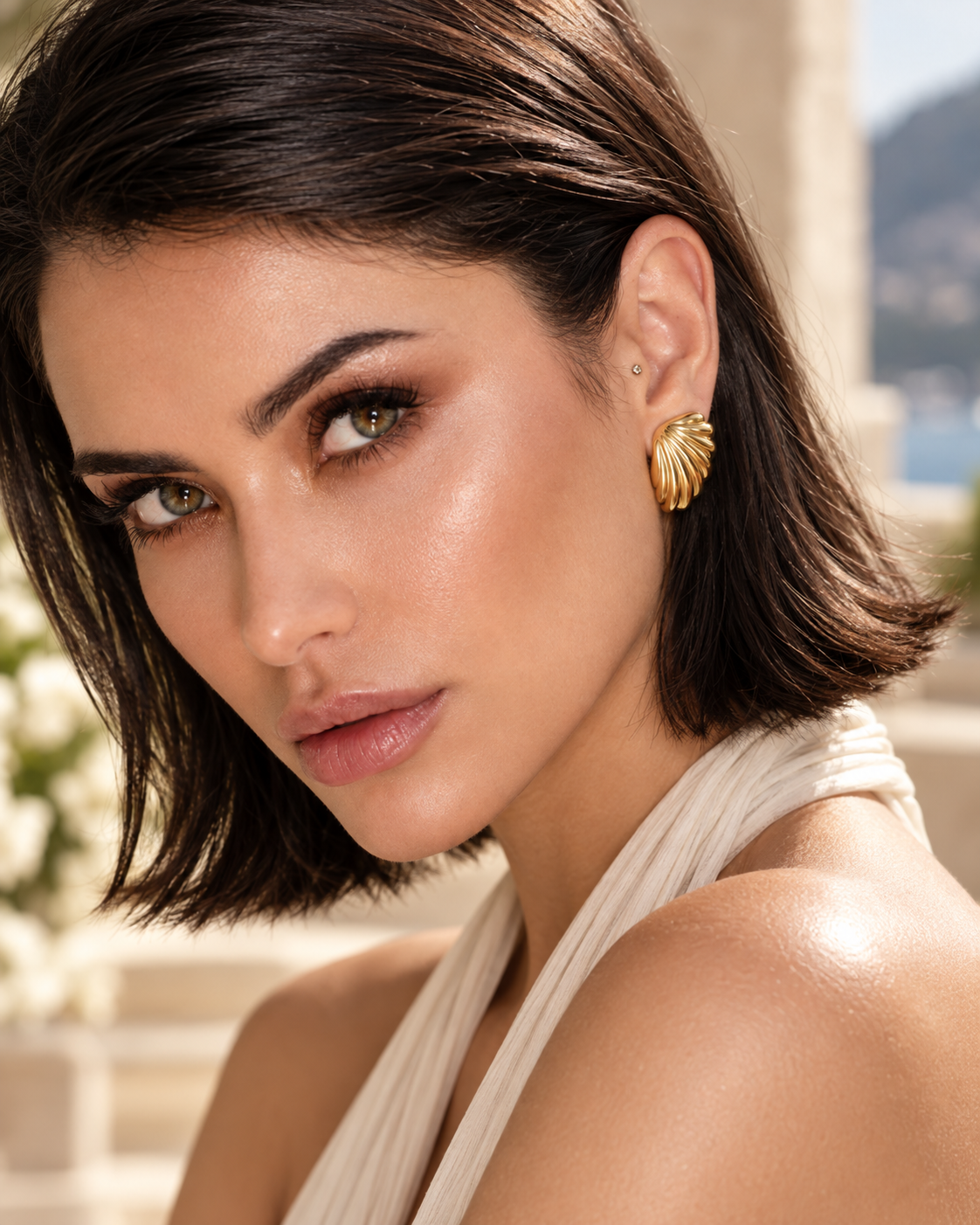a model wearing a Fluted shell gold statement earrings