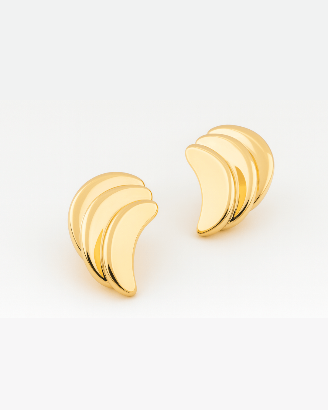Gold plated layered crescent earrings with sculptural overlapping curved design and polished finish, 48mm by 30mm