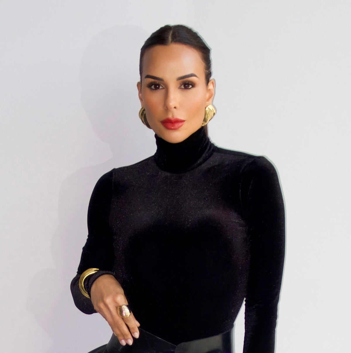 a model wearing a Triple wave gold statement earrings 