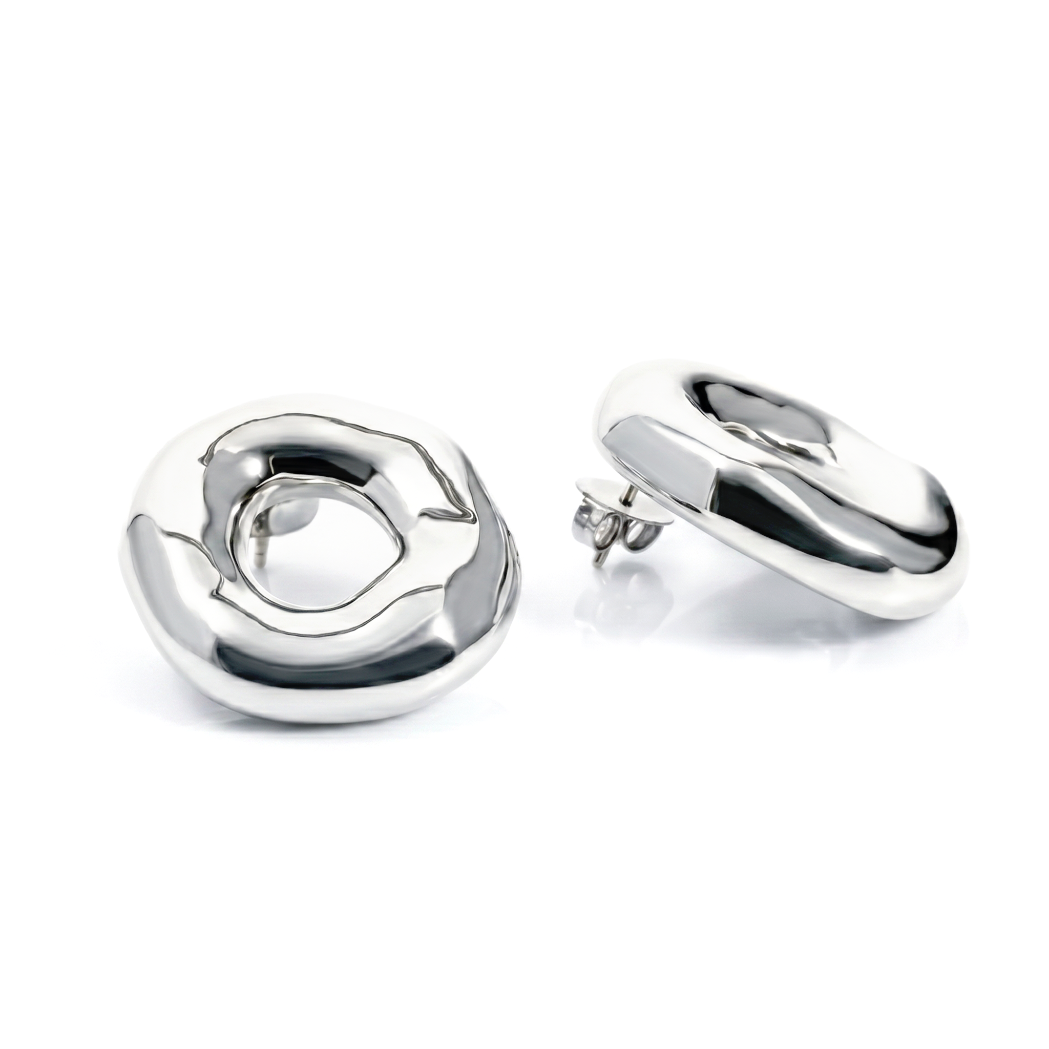 Melted circle earrings available in gold plated and rhodium plated finishes with sculptural curved design