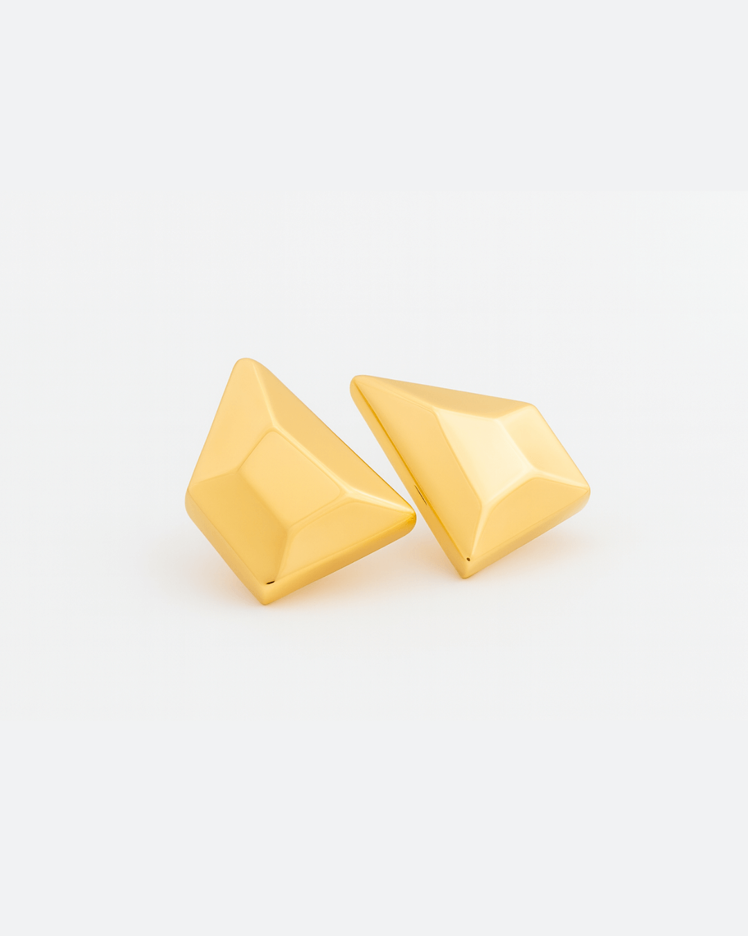 Gold plated faceted pyramid earrings with beveled edges and asymmetric geometric design, 48mm by 34mm