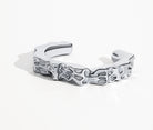 Sculpted hammered cuff bracelet available in gold plated and rhodium plated finishes with organic texture