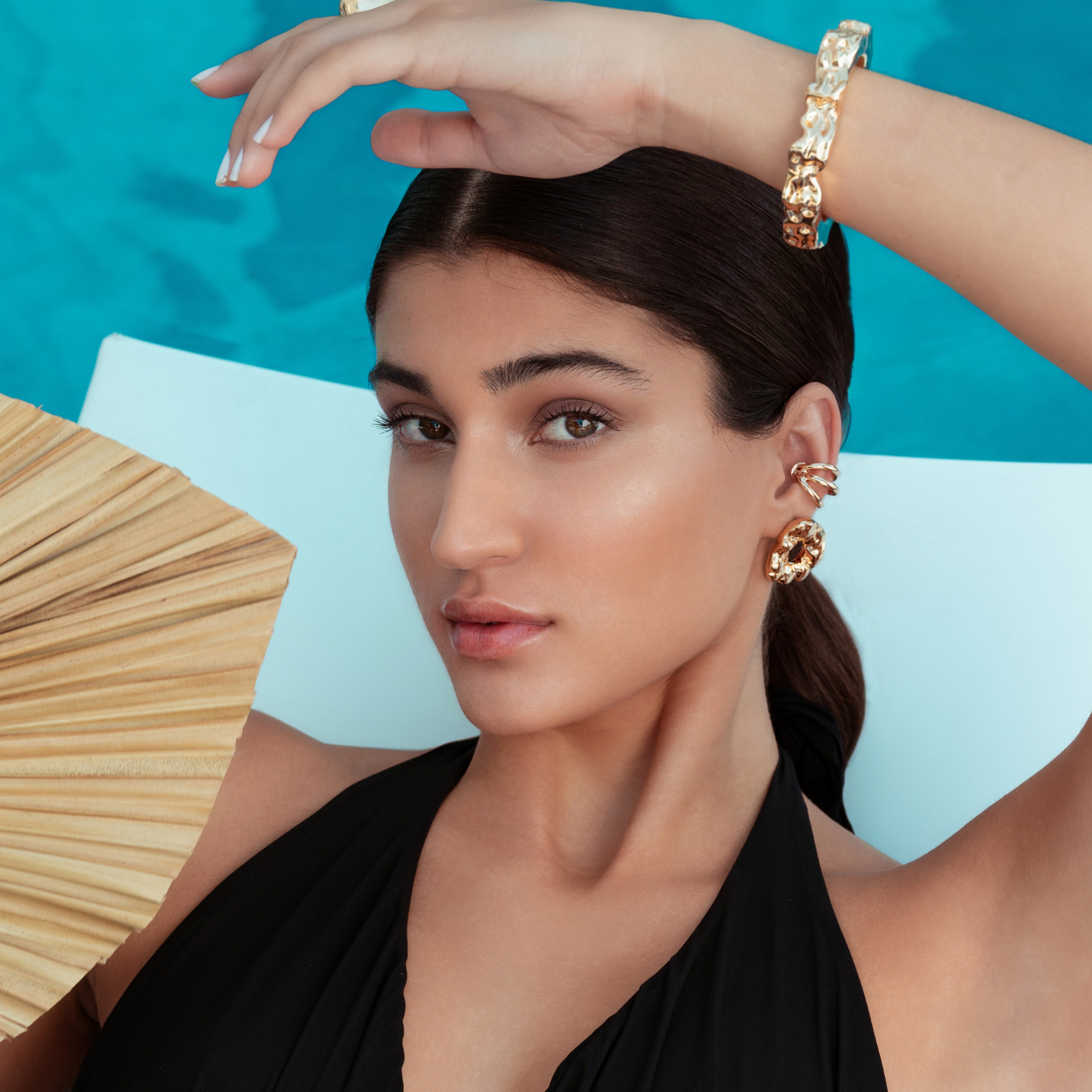 Triple strand ear cuff available in gold plated and rhodium plated finishes with sculptural layered design
