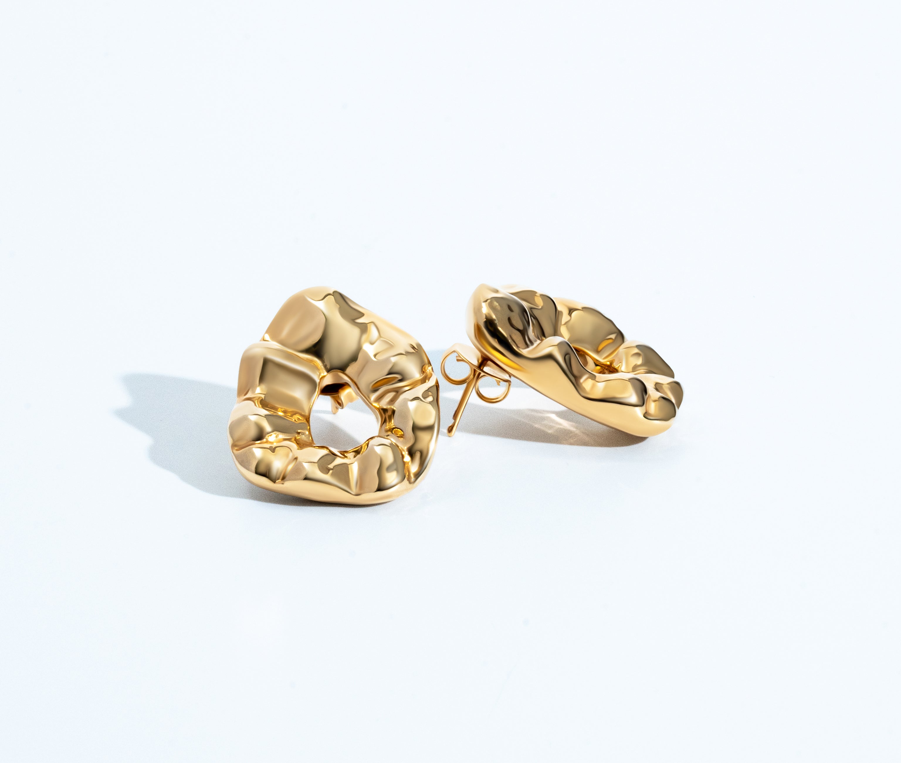 Sculptural hammered earrings available in gold plated and rhodium plated finishes with organic texture