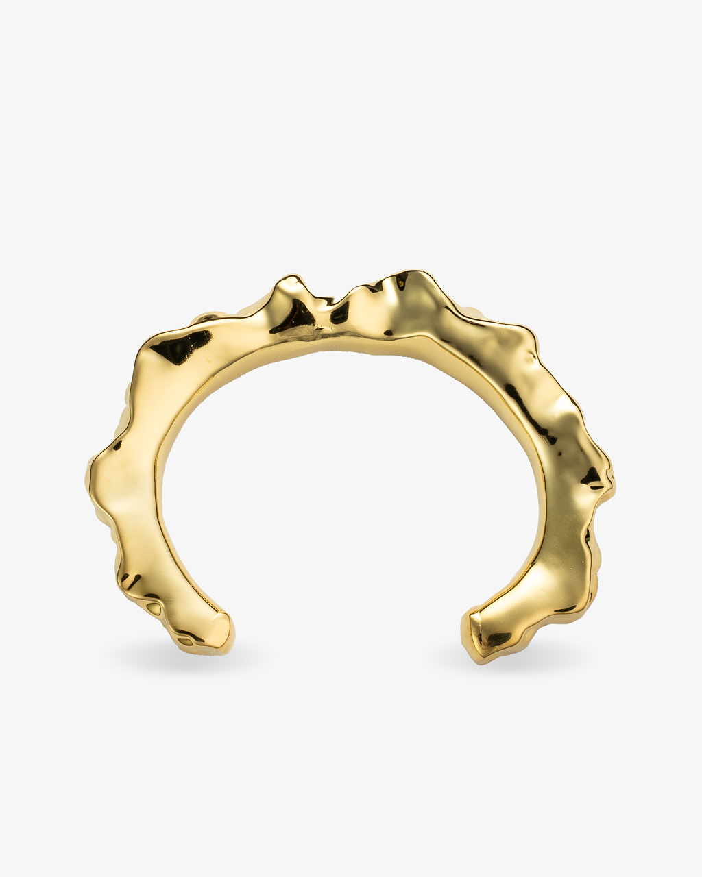 Sculptural gold cuff bracelet with irregular hammered texture