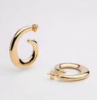 Gold plated loop dangle earrings with fluid curved design and polished finish