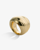 Polished chunky gold ring side view with curved sculptural design