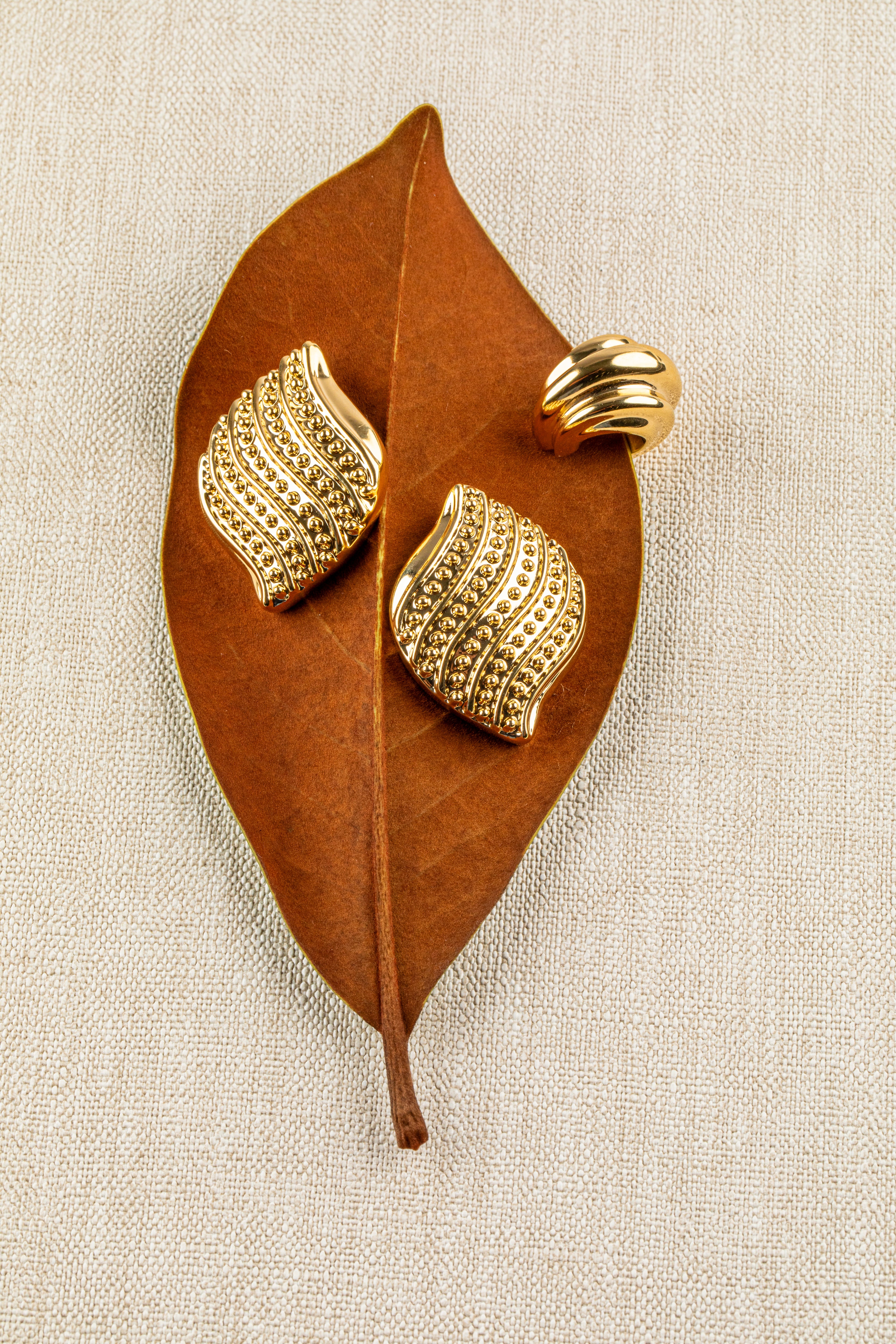 Gold plated layered ear cuff with stacked bands and thick structured design, no piercing required
