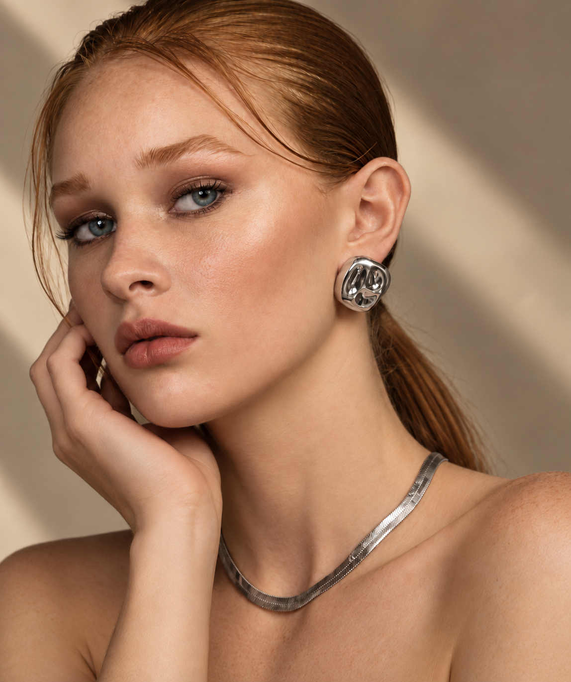 a model wearing a Organic square silver statement earrings