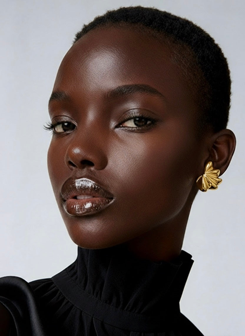 Gold plated fan-shaped sculptural earrings with layered radiating design and polished finish