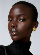 Gold plated fan-shaped sculptural earrings with layered radiating design and polished finish