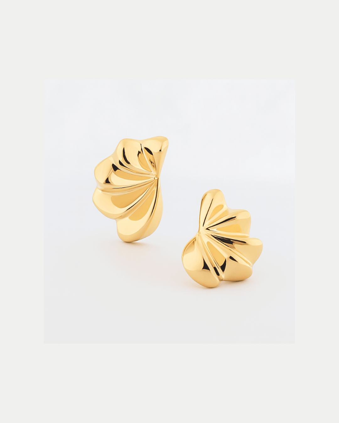 Gold plated fan-shaped sculptural earrings with layered radiating design and polished finish