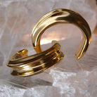 Gold plated cuff bracelet with smooth polished surface and sculptural open design, 24mm width