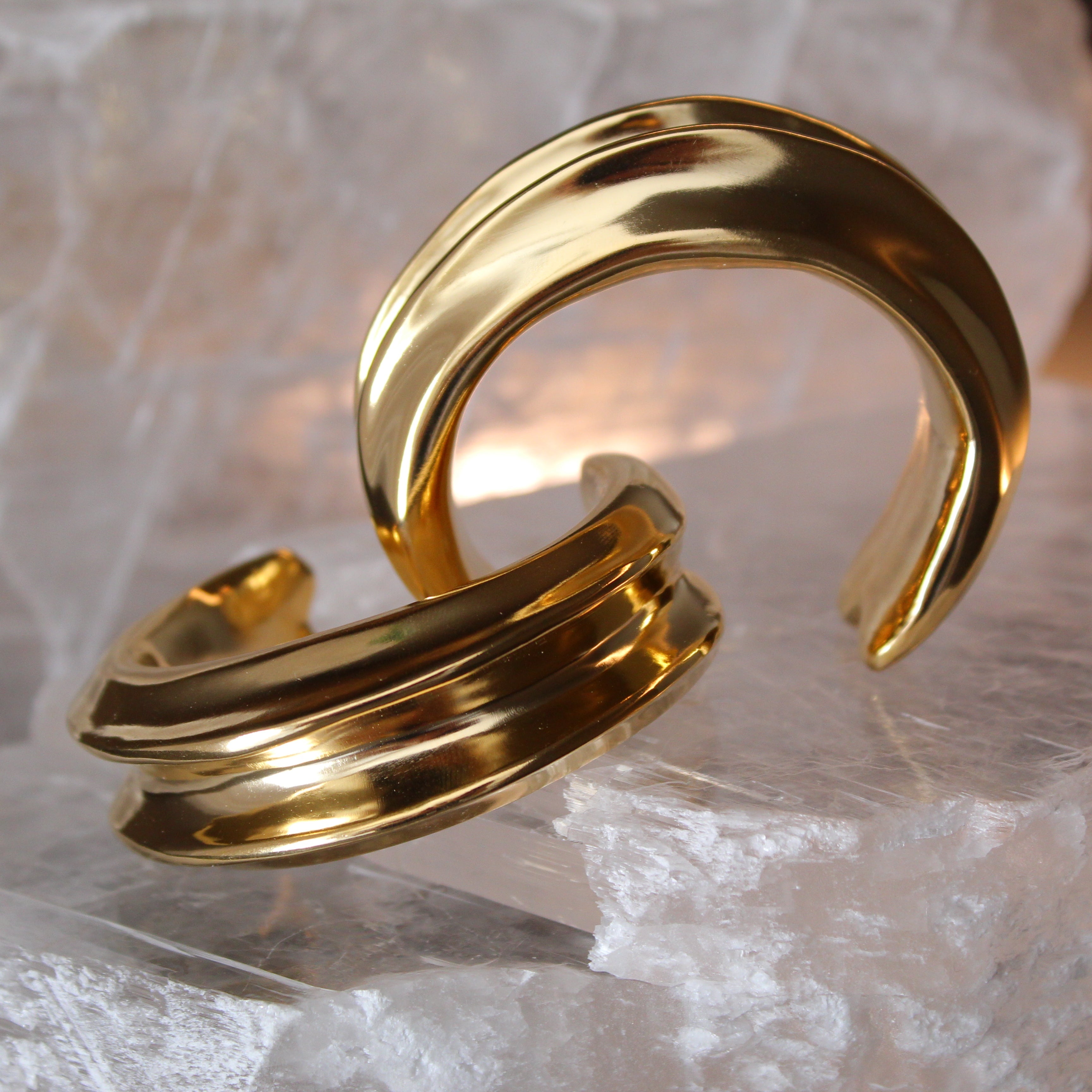 Gold plated cuff bracelet with smooth polished surface and sculptural open design, 24mm width