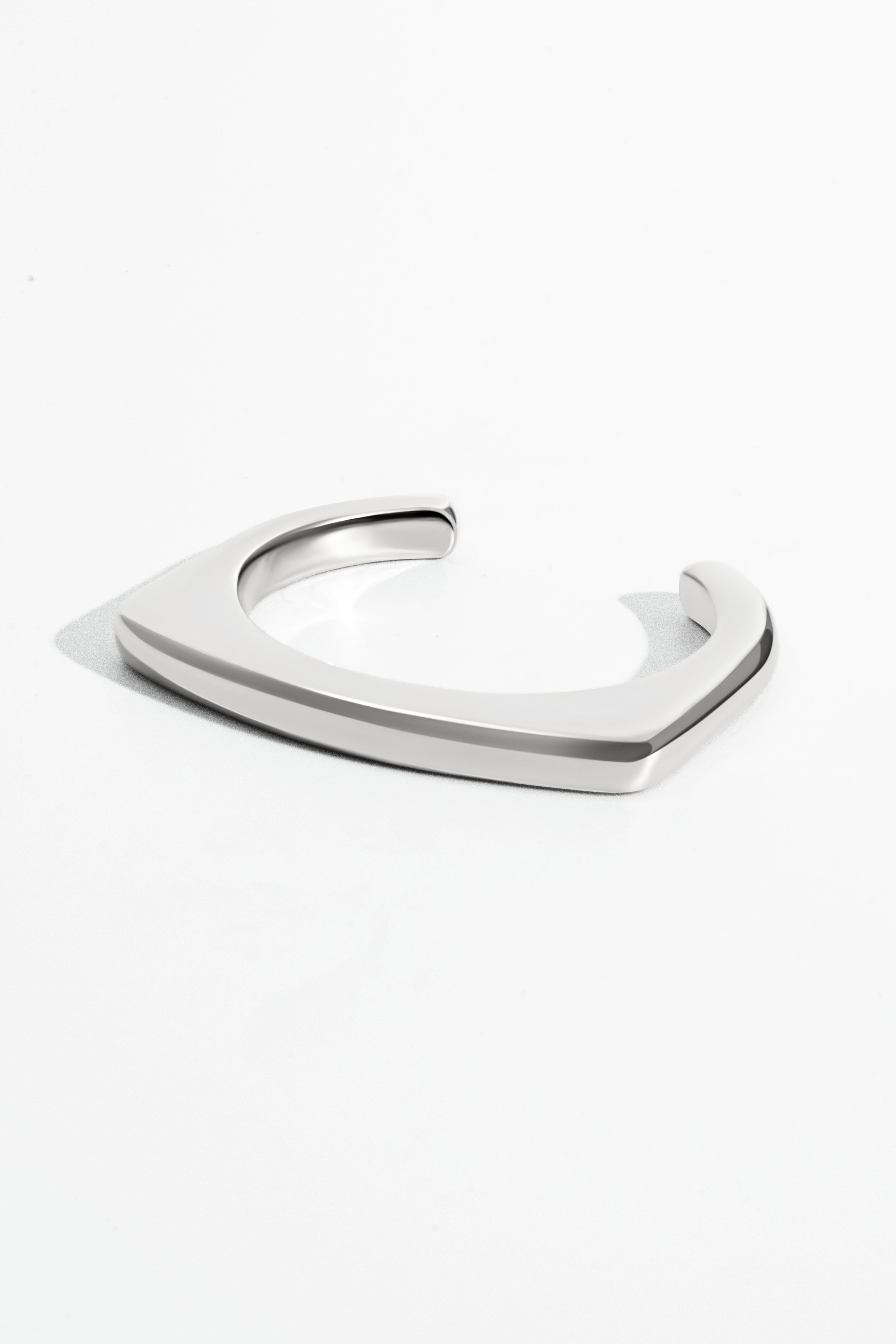 Geometric open-frame earrings available in gold plated and rhodium plated finishes with architectural design