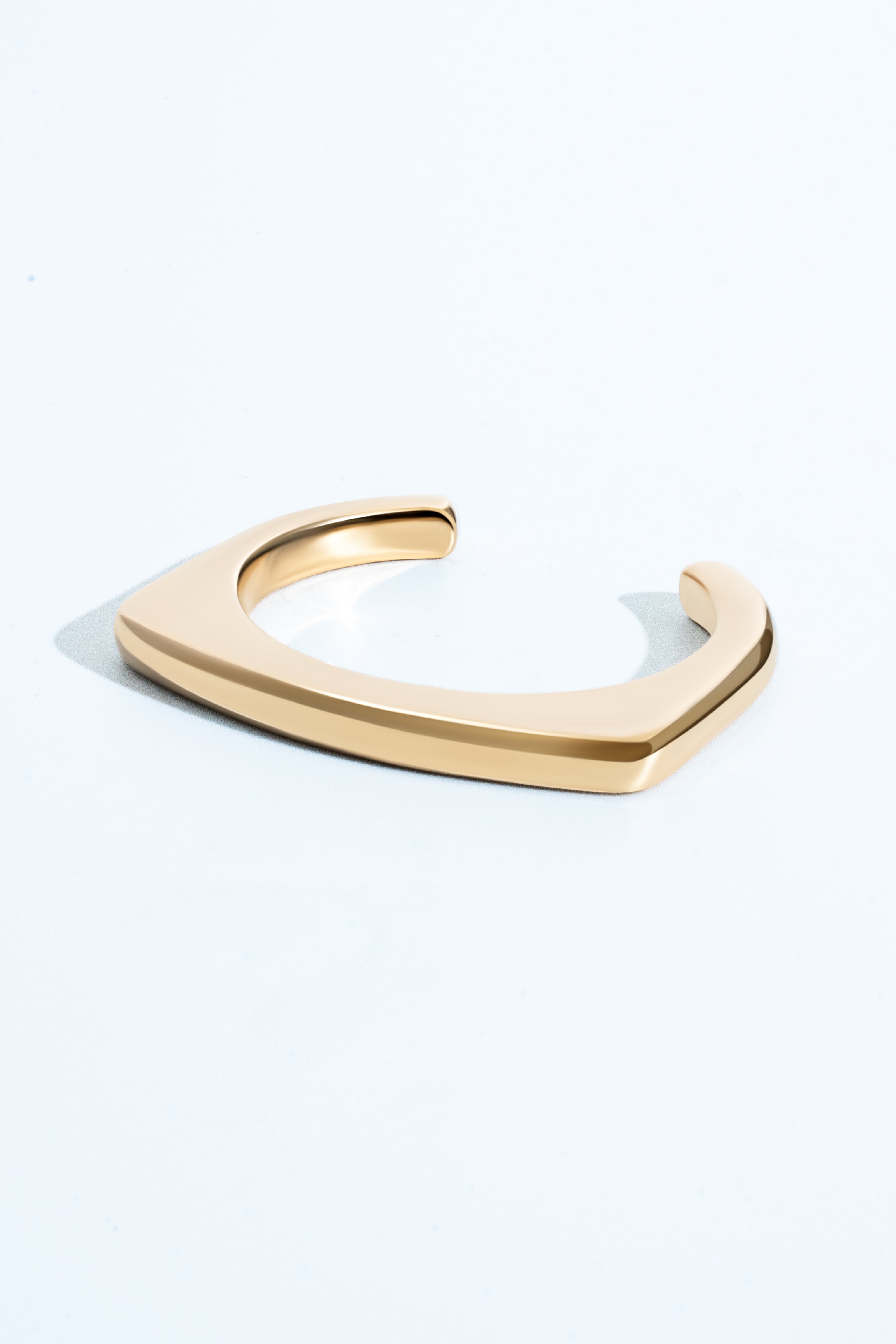 Geometric open-frame earrings available in gold plated and rhodium plated finishes with architectural design