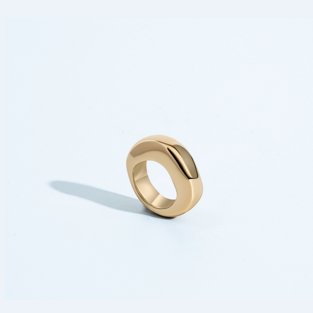 Gold sculptural ring with organic circular shape and polished finish