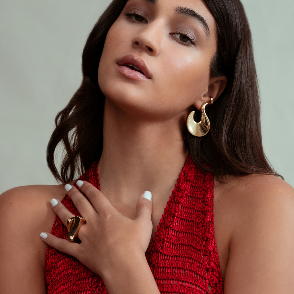 Abstract hook earrings available in gold plated and rhodium plated finishes with sculptural curved design
