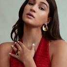 Abstract hook earrings available in gold plated and rhodium plated finishes with sculptural curved design