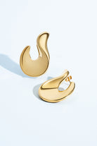 Abstract hook earrings available in gold plated and rhodium plated finishes with sculptural curved design