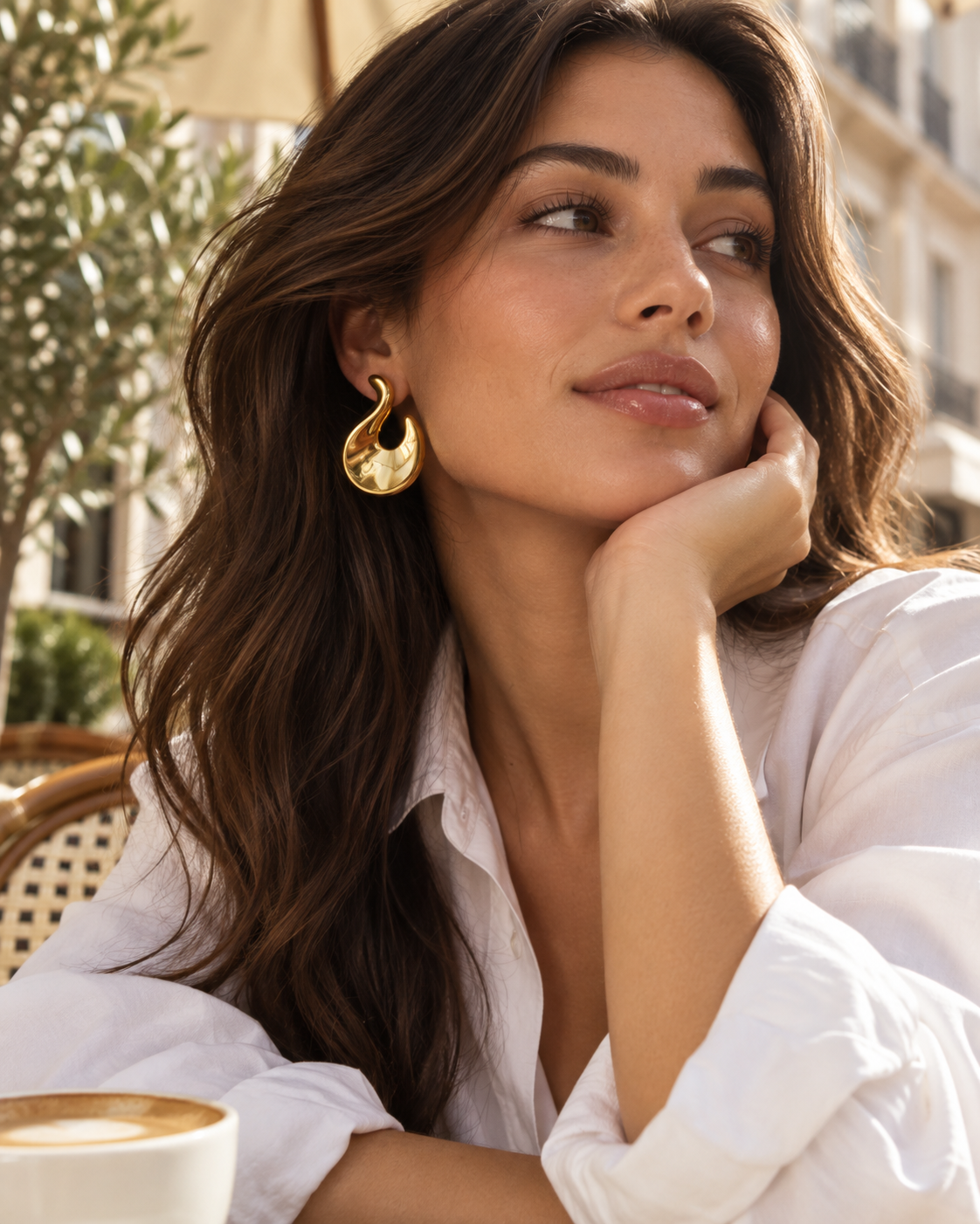 a model wearing a Sculptural flame gold statement earrings