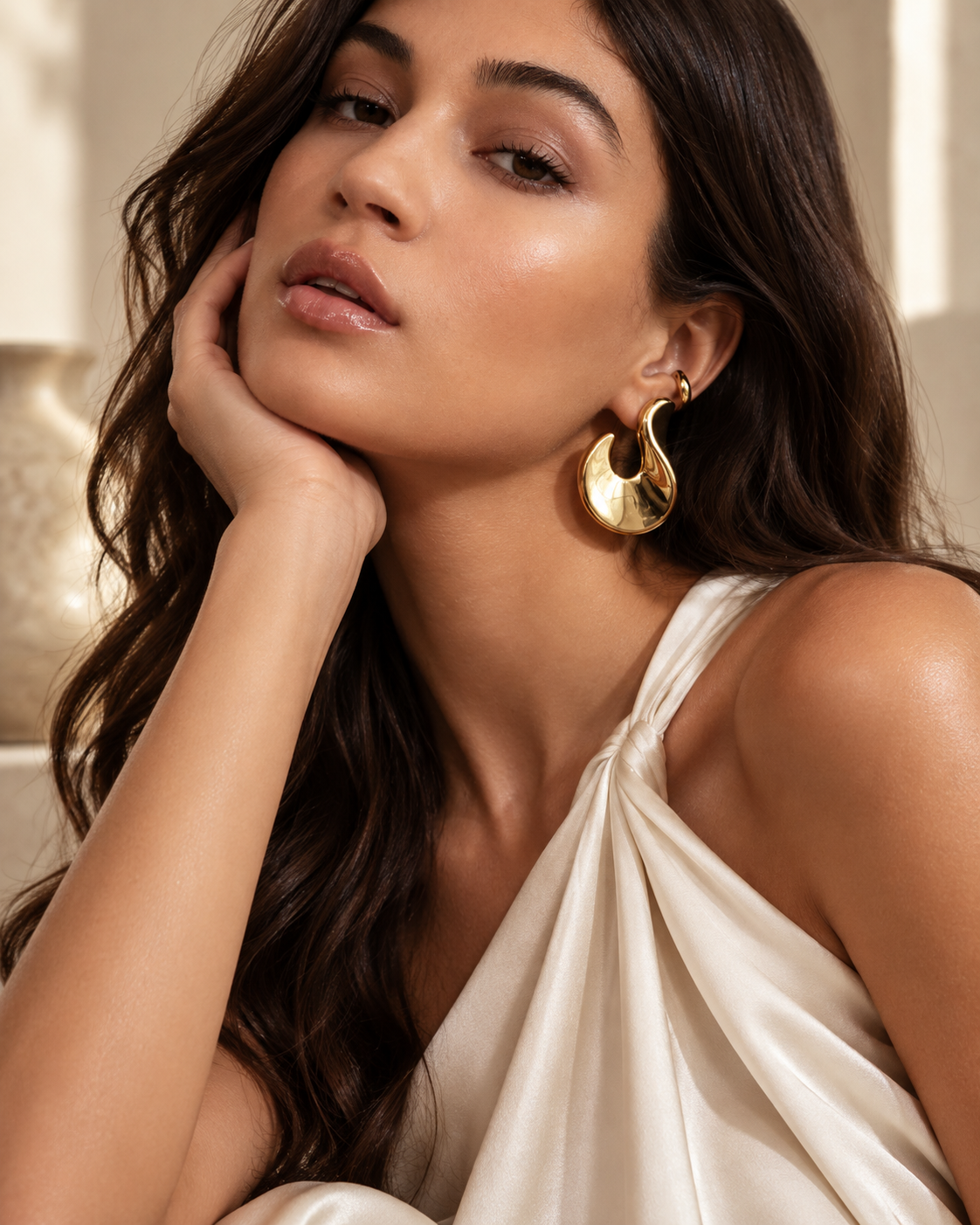 a model wearing a Sculptural flame gold statement earrings