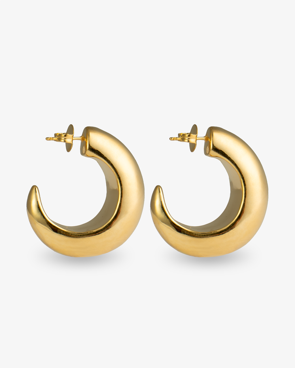Chunky sculptural gold hoop earrings angled side view