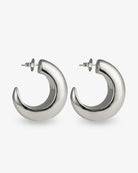 Chunky sculptural silver hoop earrings angled side view