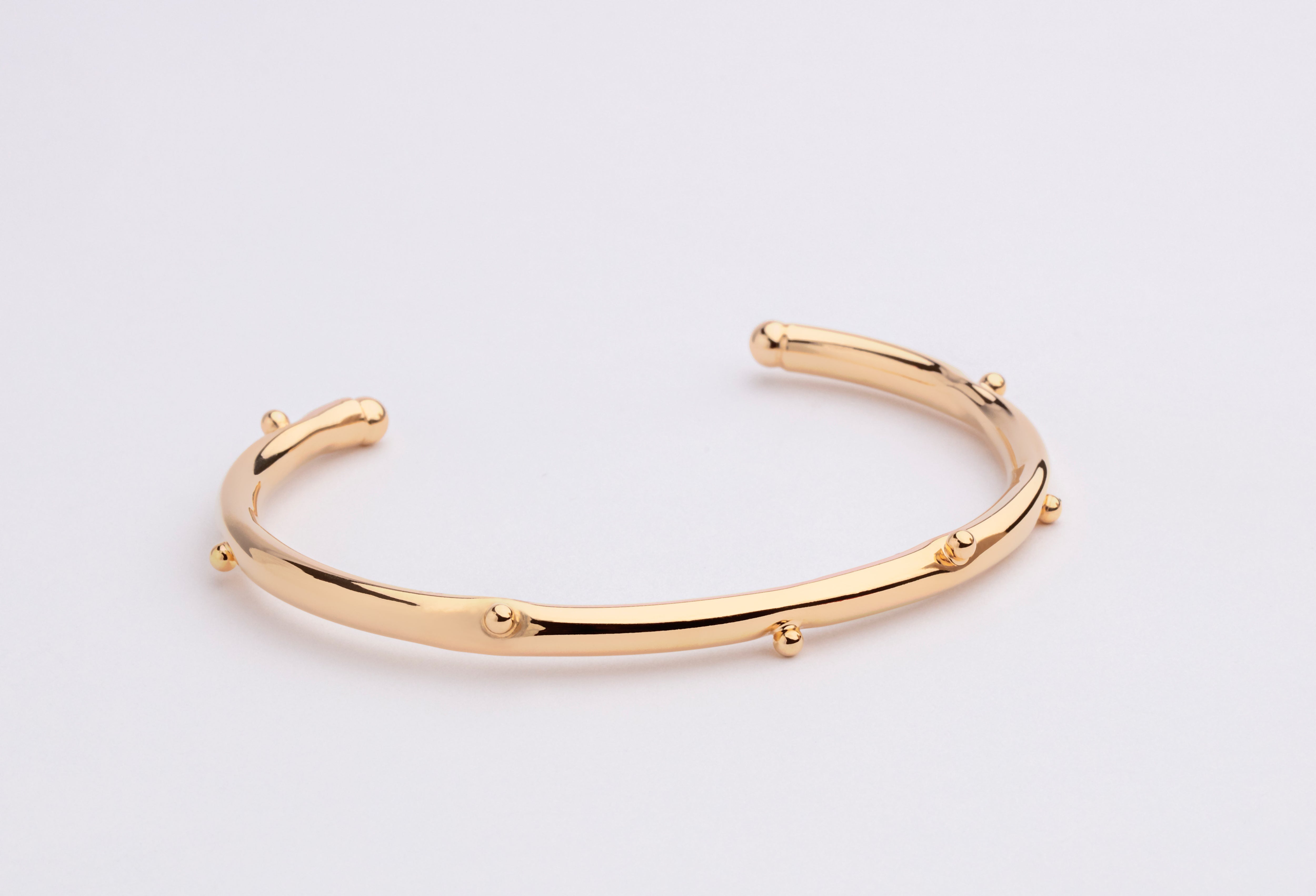 Gold plated bracelet with clean structured design and polished finish